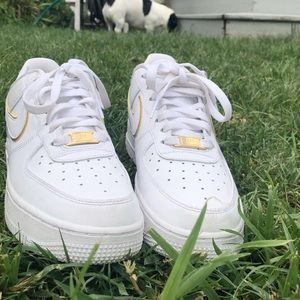 Woman’s Nike Air Force 1’s with gold highlights